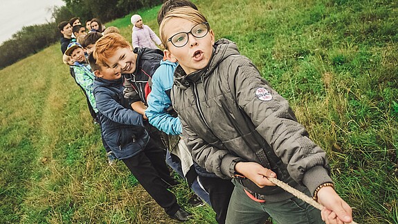 Weltkindertag Kinder und Jugendliche ziehen an einem Seil