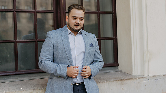 Matthäus Fandrejewski, Vorsitzender dbb jugend Matthäus Fandrejewski, Vorsitzender dbb jugend, steht vor einer Fensterfront eines Altbaugebäudes